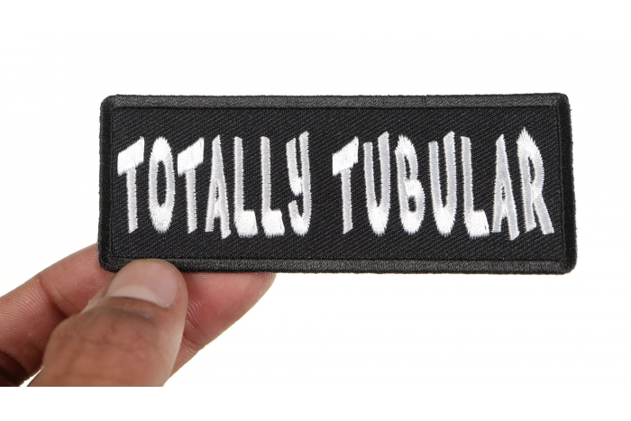 Totally Tubular Funny Iron on Patch shown on hand for size comparison