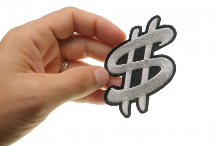 Dollar Sign Iron on Novelty Patch shown on hand for size comparison