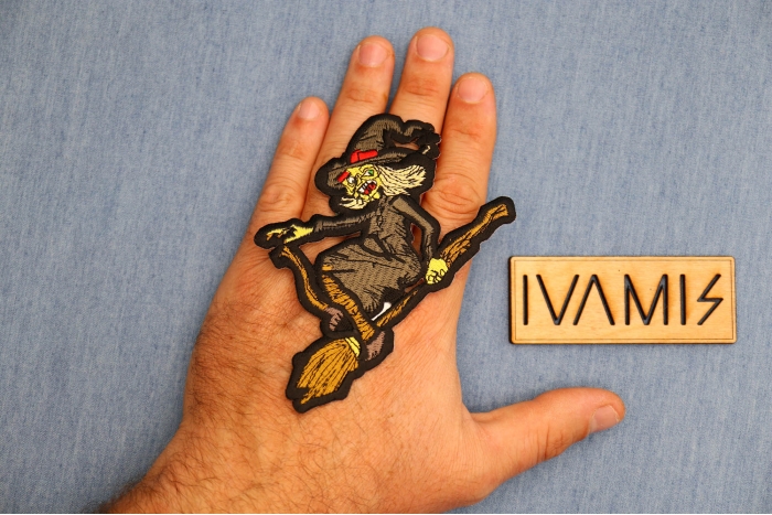 Witch on a Broom Patch shown on hand for size comparison