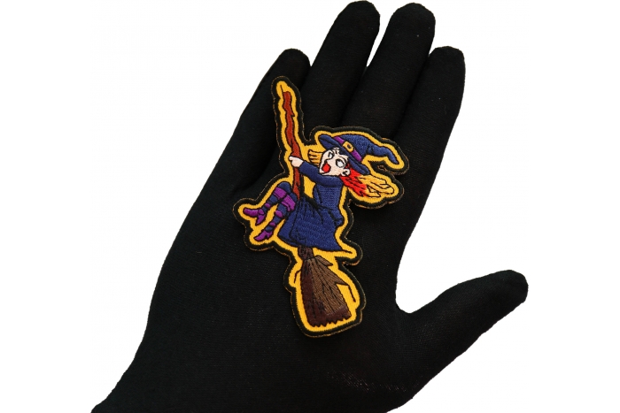 Witch on a Broom Patch shown on hand for size comparison