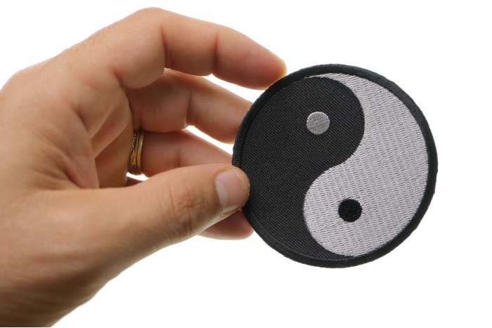 Ying Yang Novelty Iron on Patch shown on hand for size comparison