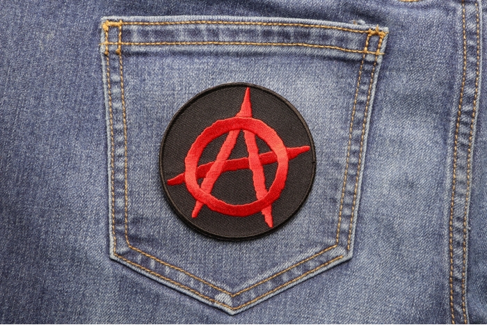 Anarchy Red Round Novelty Iron on Patch shown on jeans