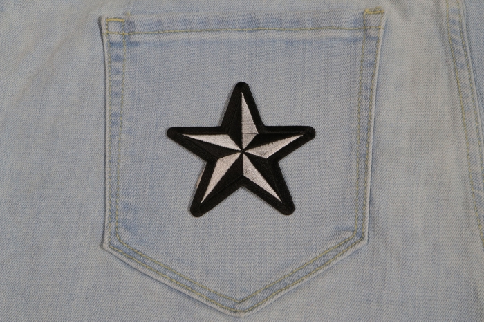 Black White Nautical Star Iron on Novelty Patch shown on jeans