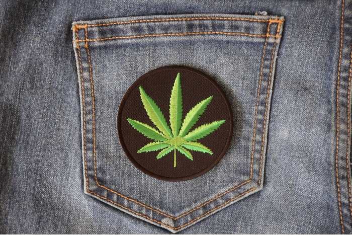 Cannabis Leaf Novelty Iron on Patch shown on jeans