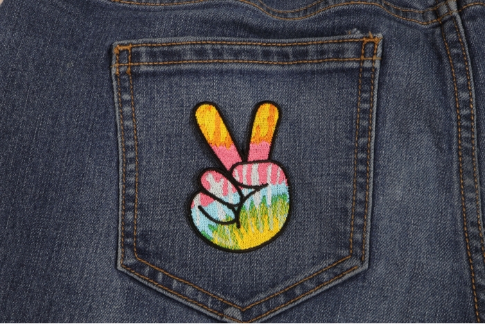 Colorful Peace Fingers Hand Sign Novelty Iron on Patch shown on jeans