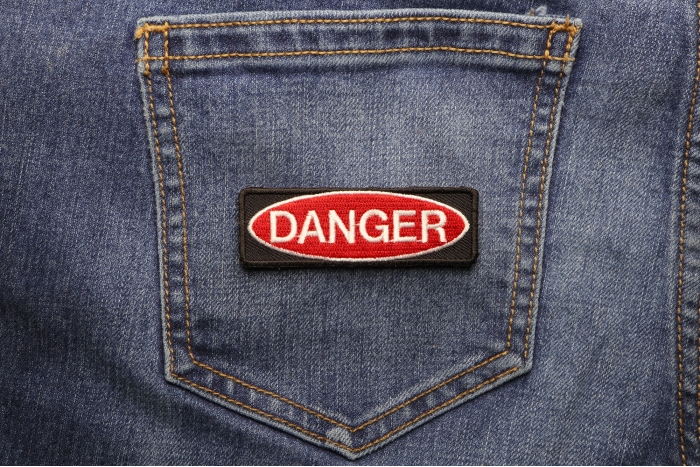 Danger Iron on Novelty Patch shown on jeans