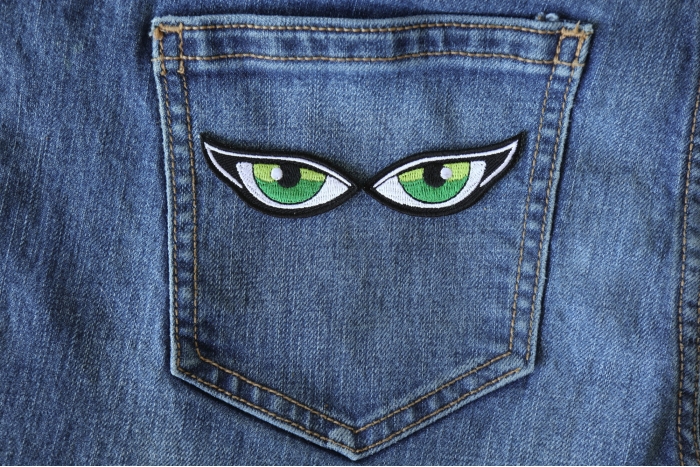 Iron on Green Eye Patches shown on jeans