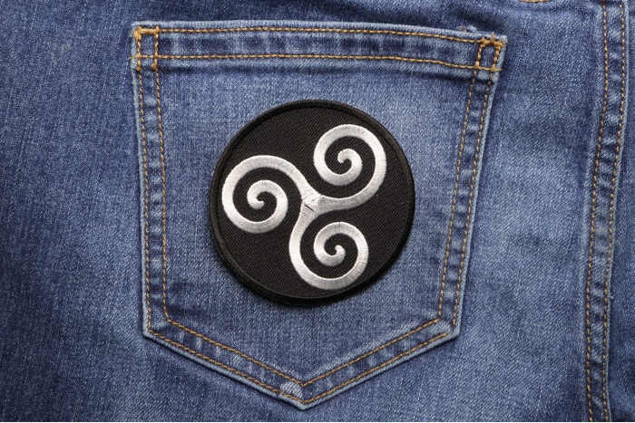 Karma Symbol Iron on Novelty Patch shown on jeans