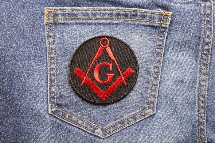 Mason Symbol Novelty Iron on Patch In Red shown on jeans