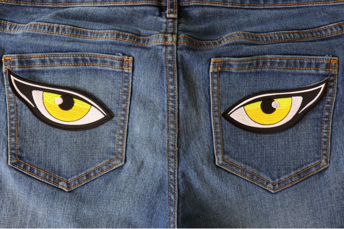 Medium Yellow Eyes Iron on Patch shown on jeans
