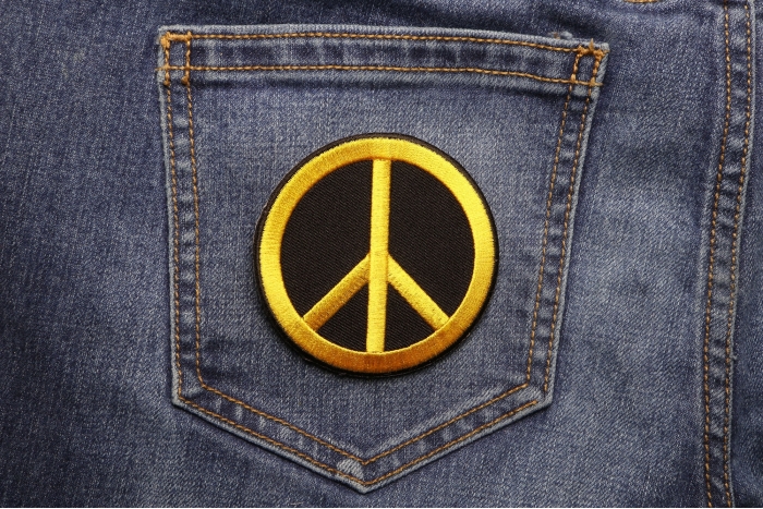 Peace Sign Iron on Patch Yellow On Black shown on jeans