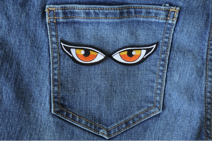 Orange Eyes Patches shown on jeans