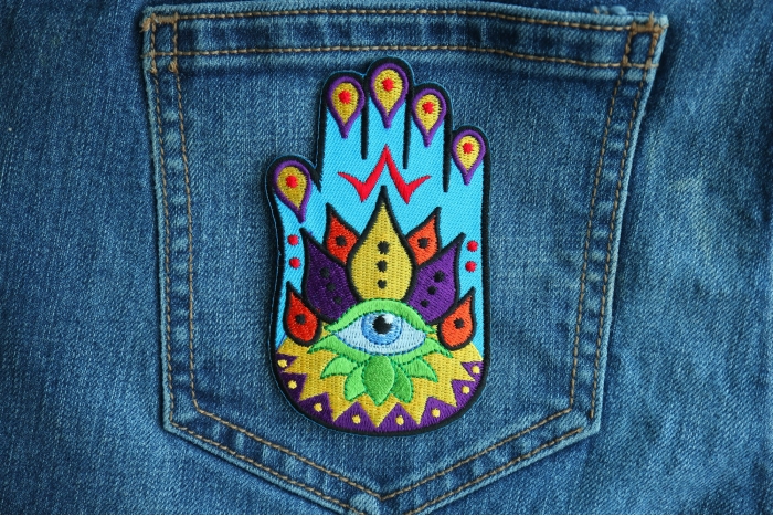 Spiritual Hand Novelty Iron on Patch shown on jeans
