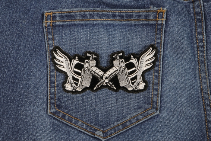 Tattoo Guns Wings Novelty Iron on Patch shown on jeans