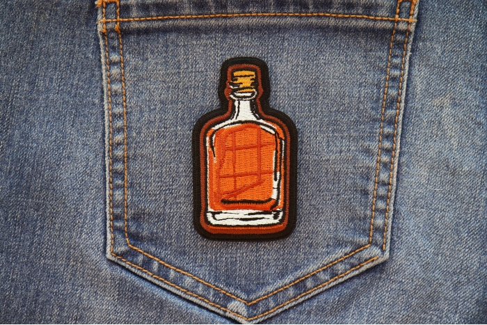 Whiskey Bottle Iron on Patch shown on jeans