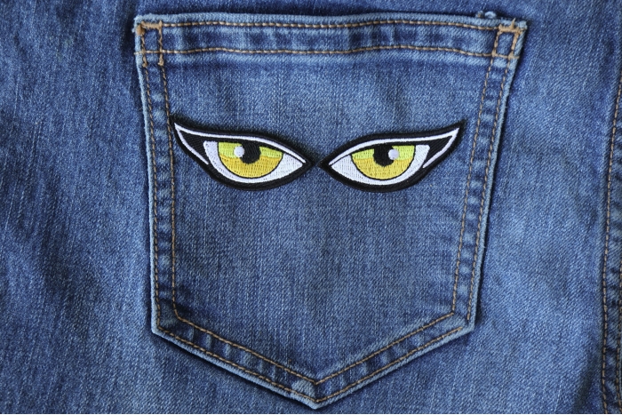 Yellow Eyes Iron on Patch shown on jeans