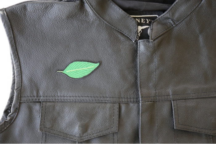 Green Leaf Patch - 3x1.25 inch. Embroidered Iron on Patch shown on leather vest