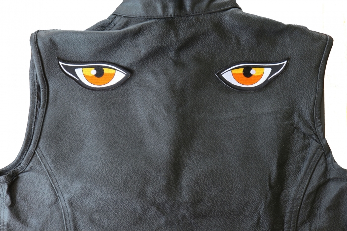 Medium Orange Eyes Patch - 4.5x1.75 inch - Embroidered Iron on Patch shown on leather vest