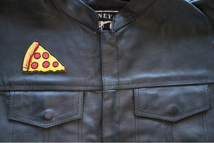 Pizza Slice Iron on Patch shown on leather vest