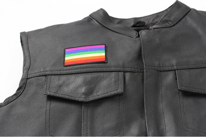 Rainbow Flag Patch - 3x2 inch. Embroidered Iron on Patch shown on leather vest