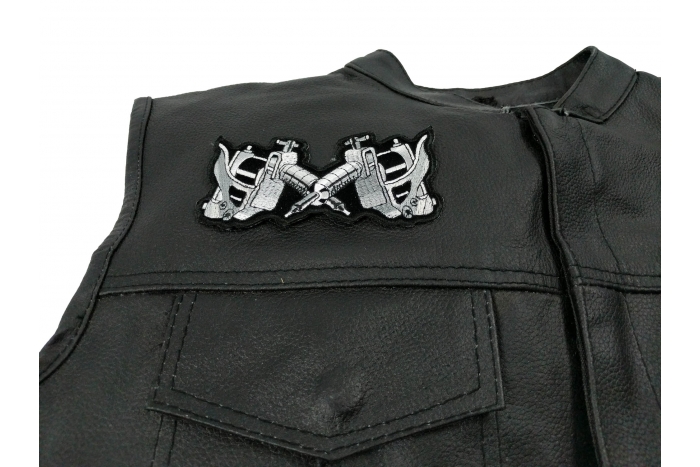 Small Tattoo Guns Patch - 4.5x2.25 inch. Embroidered Iron on Patch shown on leather vest