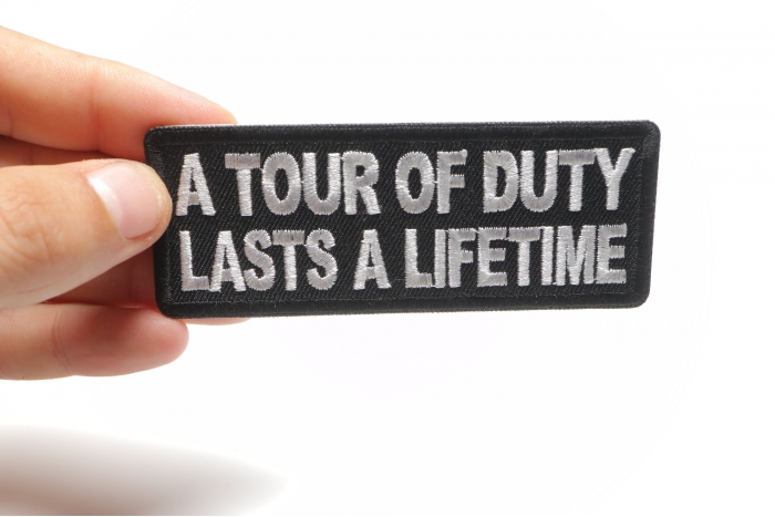 A Tour of Duty Lasts a Lifetime Patch, Military Saying Patches shown on hand for size comparison
