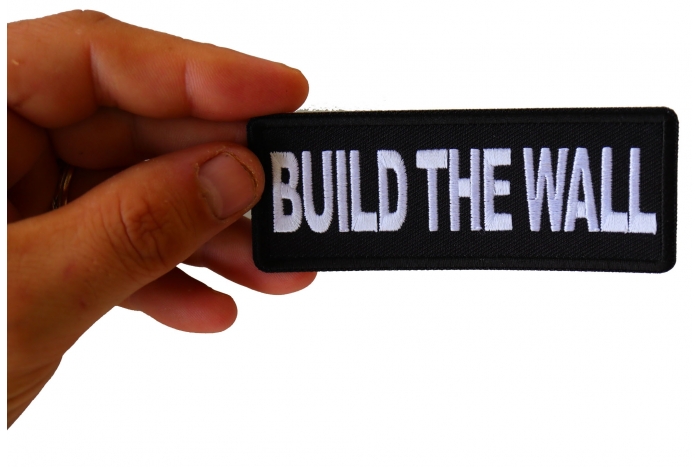 Build The Wall Patch, Patriotic Saying Patches shown on hand for size comparison