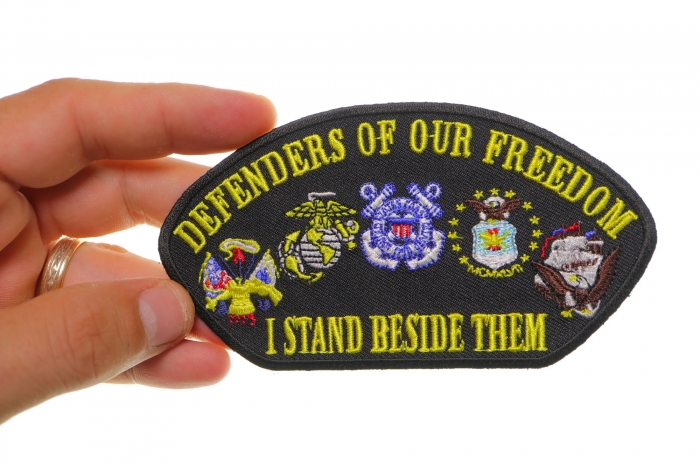 Cap Defenders Of Our Freedom I Stand Beside Them Patriotic Iron on Patch shown on hand for size comparison