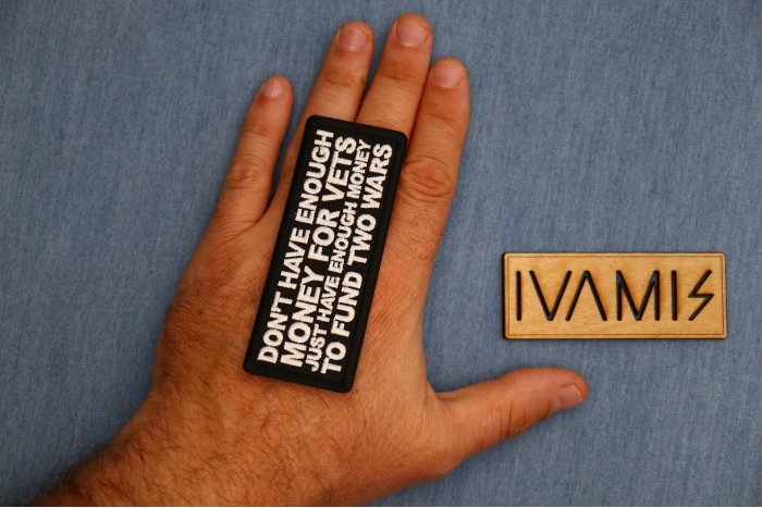 Don't Have Enough Money for Vets Just Have Enough Money to Fund Two Wars Patch shown on hand for size comparison