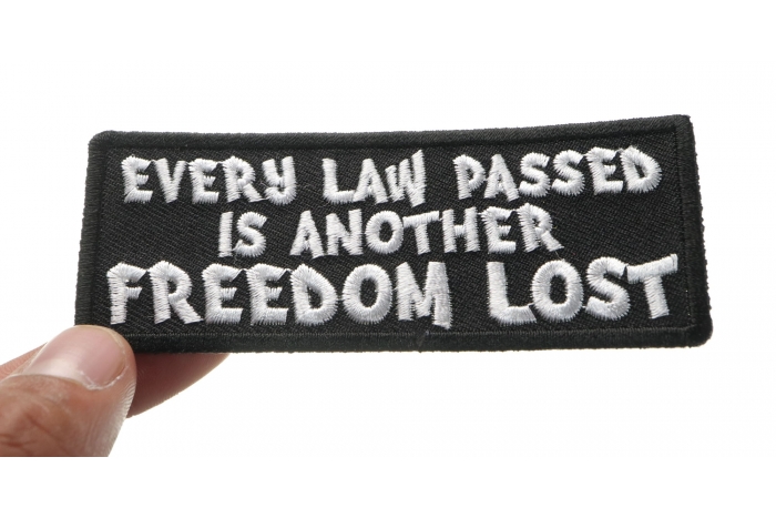 Every Law Passed is Another Freedom Lost Patriotic Iron on Patch shown on hand for size comparison