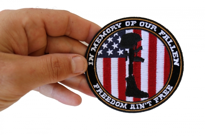 Freedom Ain't Free In Memory of Our Fallen Boot Rifle Helmet Patriotic Iron on Patch shown on hand for size comparison
