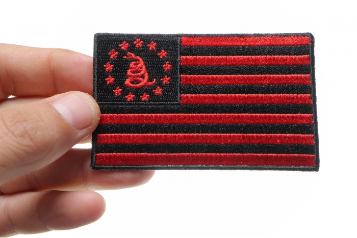 Gadsden American Flag Red Black Patch shown on hand for size comparison