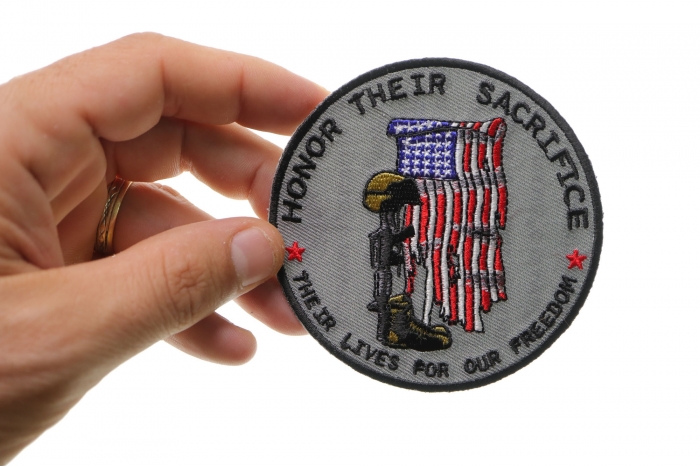 Honor Their Sacrifice Memorial Patriotic Iron on Patch shown on hand for size comparison