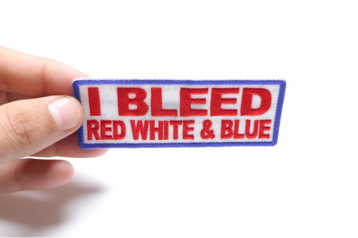 I Bleed Red White and Blue Patriotic Iron on Patch shown on hand for size comparison