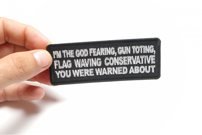 I'm The God Fearing Gun Toting Flag Waving Conservative You Were Warned About Patriotic Iron on Patch shown on hand for size comparison