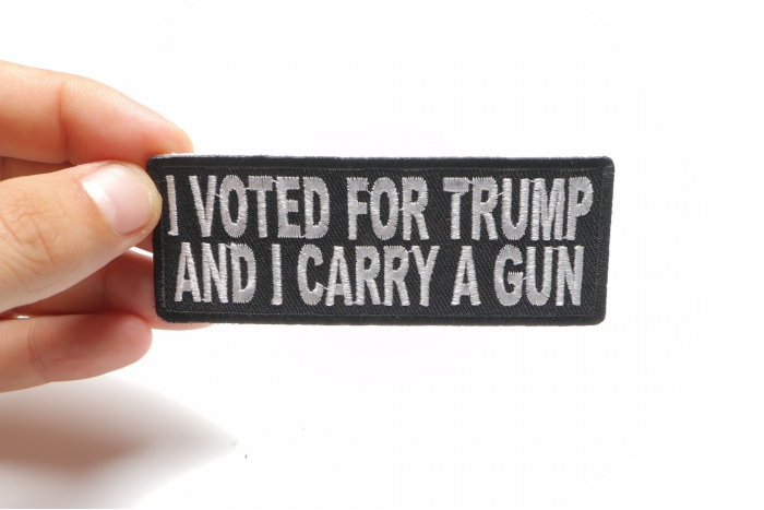 I Voted For Trump And I Carry a Gun Patch shown on hand for size comparison