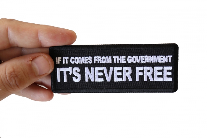 If It Comes from The Government It's Never Free Patch shown on hand for size comparison