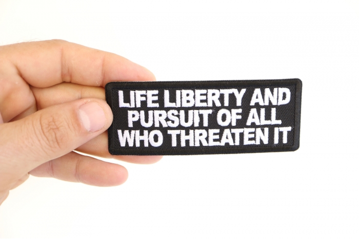 Life Liberty and Pursuit of All Who Threaten it Patriotic Iron on Patch shown on hand for size comparison