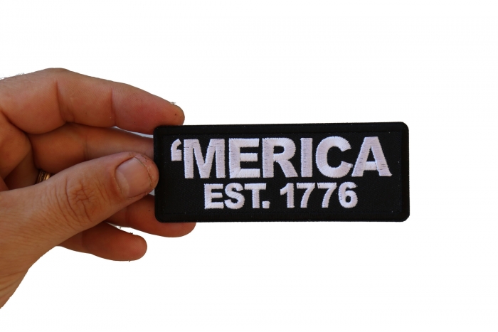 Merica Est 1776 Patriotic Iron on Patch shown on hand for size comparison