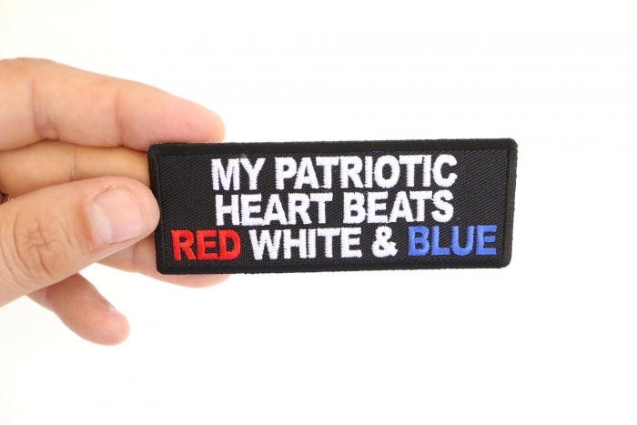 My Patriotic Heart Beats Red White and Blue Iron on Patch shown on hand for size comparison