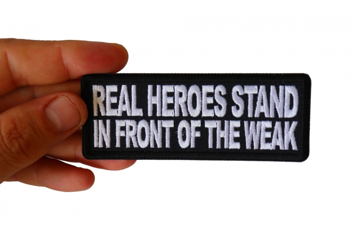 Real Heroes Stand In front of the Weak Patriotic Iron on Patch shown on hand for size comparison