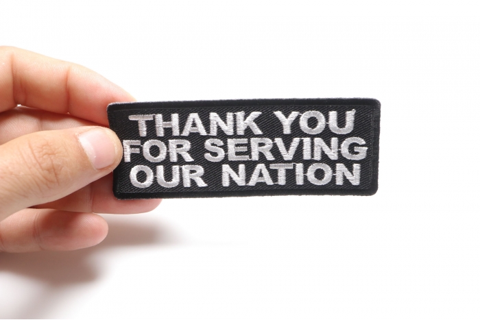 Thank You For Serving Our Nation Patriotic Iron on Patch shown on hand for size comparison