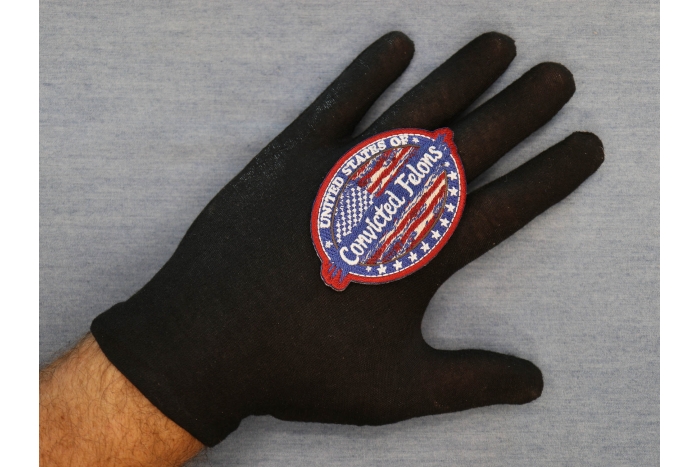 United States of Convicted Felons Patch shown on hand for size comparison