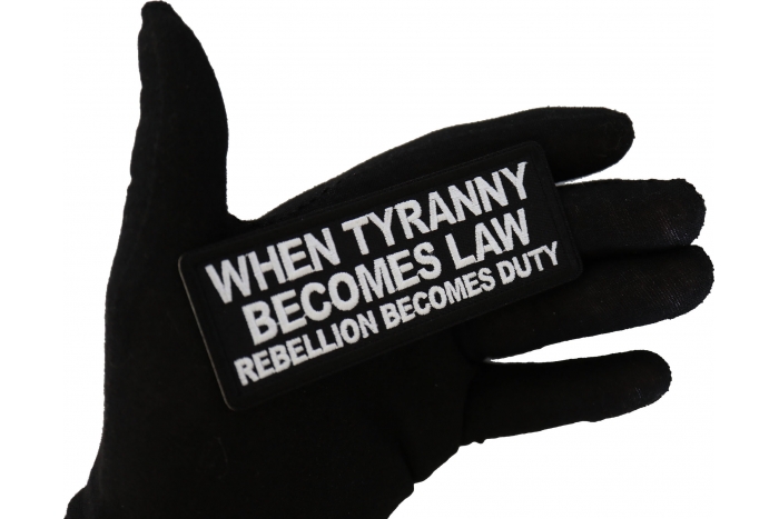 When Tyranny Becomes Law Rebellion Becomes Duty Patch, Patriotic Saying Patches shown on hand for size comparison