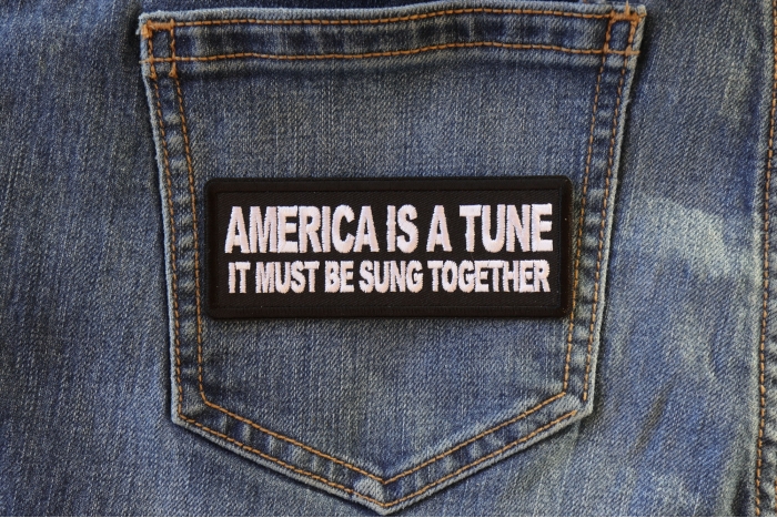 America is a Tune it must be Sung Together Patch shown on jeans