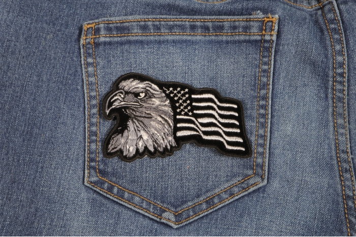Eagle With Waving Flag Black Silver Patriotic Iron on Patch shown on jeans