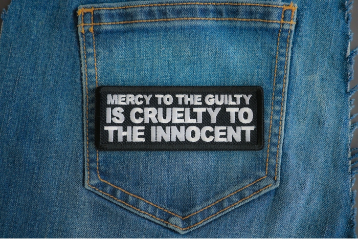 Mercy To The Guilty Is Cruelty To The Innocent Patch shown on jeans