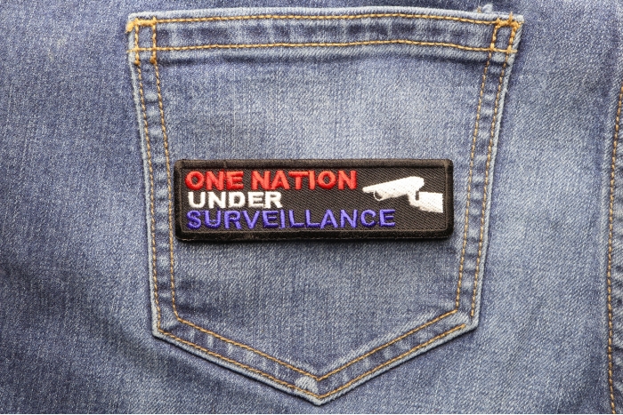 One Nation Under Surveillance Patch shown on jeans