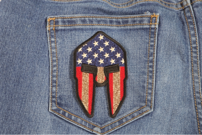 Spartan Helmet US Flag Patriotic Iron on Patch shown on jeans