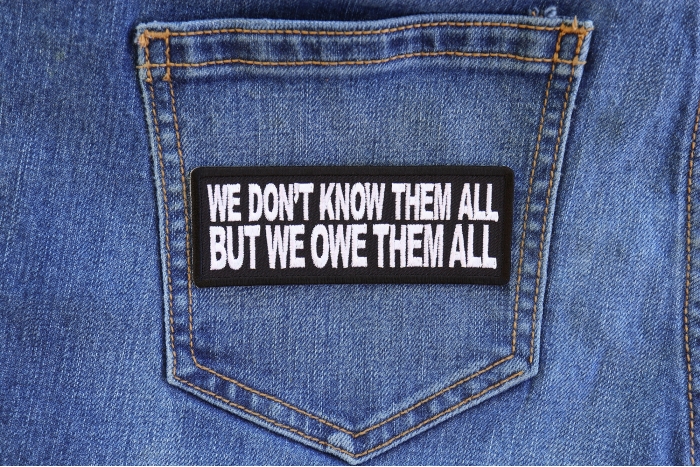 We Don't Know Them All But We Owe Them All Patriotic Iron on Patch shown on jeans